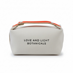 White hemp-jute cosmetic case with tangerine carry handle + embroidered Love and Light Botanicals logo, front view