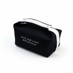 Black hemp-jute cosmetic case with white handle, angled view