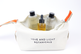 Open white hemp-jute cosmetic case holding Shine superfruit tonic, Bloom facial oil + Florafirm barrier repair essence