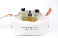 Open white hemp-jute cosmetic case holding Shine superfruit tonic, Bloom facial oil + Florafirm barrier repair essence